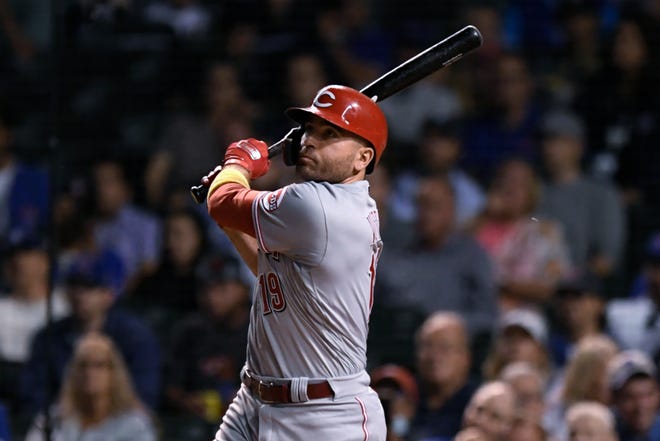 Cincinnati Reds' Joey Votto watches his solo home run during the fourth inning of the team's baseball game against the Chicago Cubs on Wednesday, Sept. 8, 2021, in Chicago. (AP Photo/Paul Beaty)