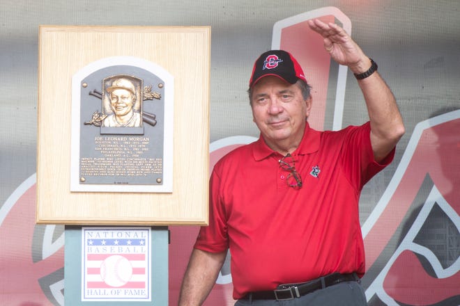 Former Cincinnati Reds catcher Johnny Bench waives while standing next to the Joe Morgan plaque from the Baseball Hall of Fame on Joe Morgan Day before MLB baseball game between the Cincinnati Reds and the Pittsburgh Pirates on Sunday, Aug. 8, 2021, at Great American Ball Park in Cincinnati. 