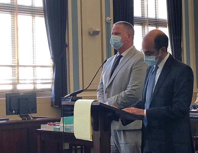 Kenneth Hackett stands to the left of his attorney, Edward Perry, at his sentencing in Hamilton County Common Pleas Court on Tuesday, Sept. 14, 2021.