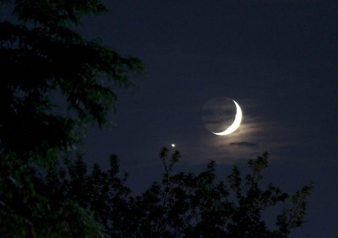 Crescent moon next to dazzling Venus.