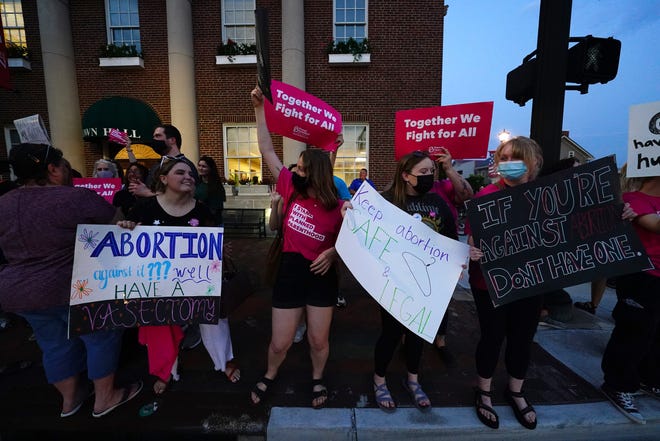 Pro-choice protesters gather outside Lebanon town hall as city council considers voting on a proposed ordinance which would declare the city of 20,000 in Warren County, north of Cincinnati, a "sanctuary city for the unborn," Tuesday, May 25, 2021, in Lebanon, Ohio. 