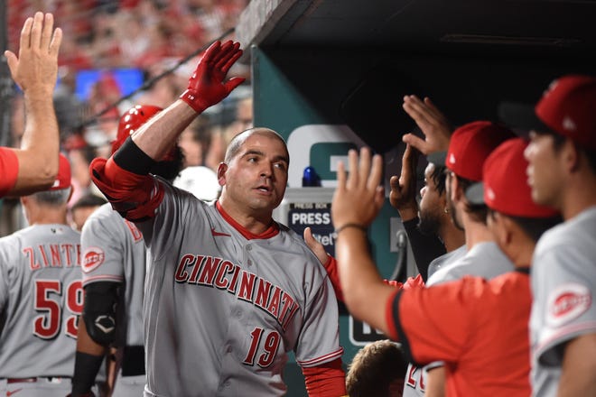 Cincinnati Reds first baseman Joey Votto (19) is congratulated after hitting a solo home-run against the St. Louis Cardinals during the fourth inning at Busch Stadium on Sept. 10.