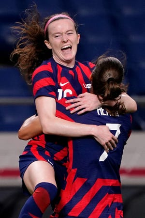 Team United States midfielder Rose Lavelle (16) celebrates with forward Tobin Heath (7) after scoring a goal during the first half against New Zealand in group G play during the Tokyo 2020 Olympic Summer Games at Saitama Stadium.