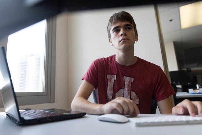 Colby Nolasco, a student in the University of Cincinnati’s IT program and full-stack developer, works on an internal web application for Macy’s, Tuesday, July 27, 2021, at the University of Cincinnati's College of Engineering and Applied Science - Victory Parkway Campus in the Walnut Hills neighborhood of Cincinnati, Ohio. Nolasco, 19, of Lebanon, Ohio, is a part of the Early IT program at the University of Cincinnati, which recruits high school students to join the program.