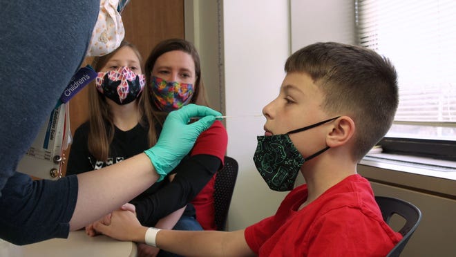 Eli Dropic gets a COVID-19 test before being a part of a clinical trial for the Pfizer COVID-19 vaccine at Cincinnati Children's Hospital Medical Center. Eli, 10, and his sister, 8, were enrolled in the trial on children ages 5-11.