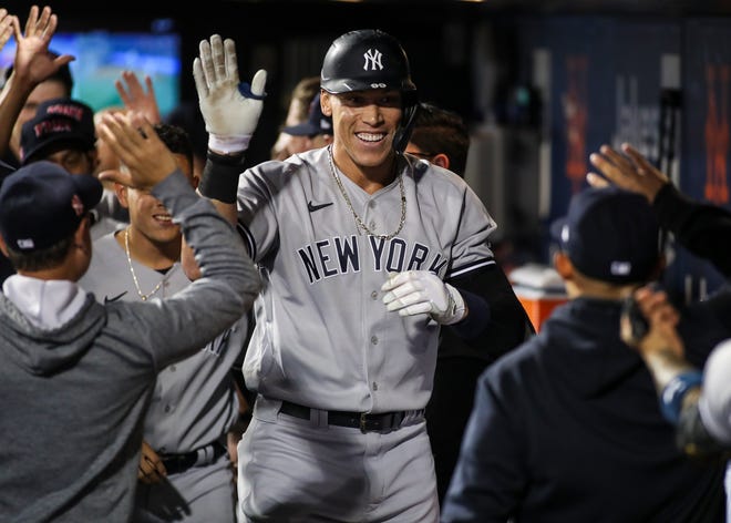 New York Yankees right fielder Aaron Judge is greeted in the dugout after hitting a solo home run in the second inning against the New York Mets at Citi Field.