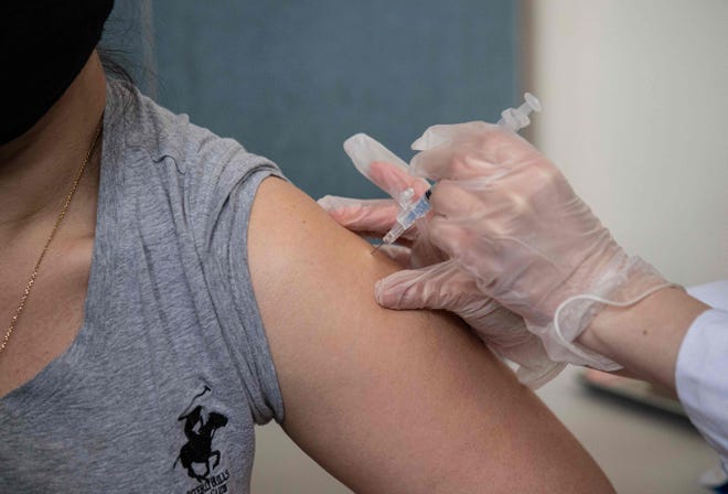 A patient receives her first dose of the Moderna Covid-19 vaccine at a pop up vaccine clinic at the Jewish Community Center on April 16, 2021 in the Staten Island borough of New York City.