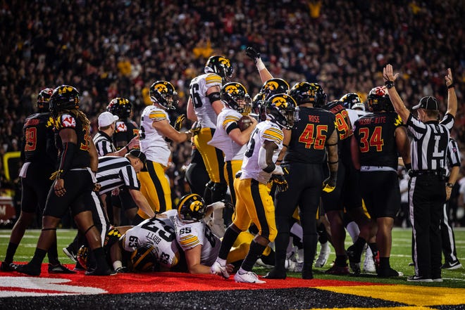 Iowa players celebrate after quarterback Spencer Petras (7) rushes for a touchdown against Maryland during the first half at Capital One Field at Maryland Stadium.