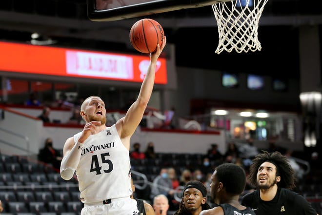 Cincinnati Bearcats guard Mason Madsen (45) scores in the first half of an NCAA men's college basketball game against the UCF Knights, Sunday, Feb. 14, 2021, at Fifth Third Arena in Cincinnati. 