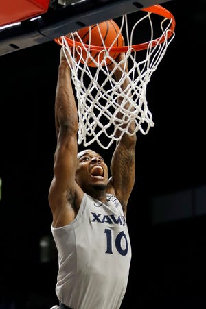 Xavier Musketeers guard Nate Johnson (10) rises for a breakaway dunk in the second half of the NCAA basketball game between the Xavier Musketeers and the Norfolk State Spartans at the Cintas Center in Cincinnati on Sunday, Nov. 21, 2021. Xavier remained unbeaten on the season with an 88-48 win over the Spartans. 