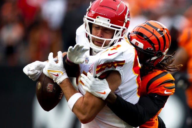 Kansas City Chiefs tight end Travis Kelce (87) drops a pass as he is hit by a bengals defender in the second half of the NFL game on Sunday, Jan. 2, 2022, at Paul Brown Stadium in Cincinnati. Cincinnati Bengals defeated Kansas City Chiefs 34-31. 