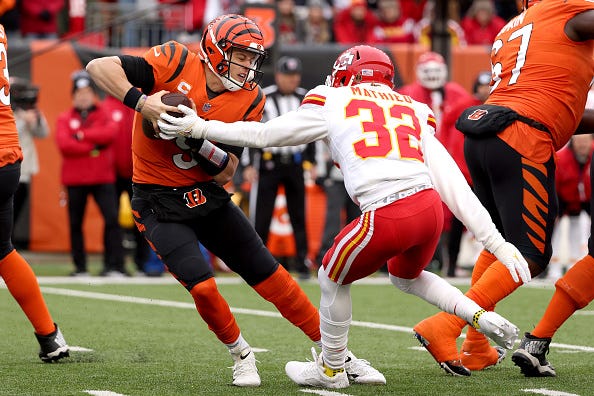 Joe Burrow #9 of the Cincinnati Bengals is pressured by Tyrann Mathieu #32 of the Kansas City Chiefs in the first quarter of the game at Paul Brown Stadium on January 02, 2022 in Cincinnati, Ohio.
