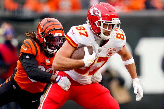 Kansas City Chiefs tight end Travis Kelce (87) maintains possession after a catch as Cincinnati Bengals cornerback Tre Flowers (33) defends in the second quarter during a Week 17 NFL game, Sunday, Jan. 2, 2022, at Paul Brown Stadium in Cincinnati.