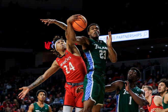 Tulane Green Wave guard R.J. McGee (23) grabs a rebound against UC's Jeremiah Davenport last Jan. 1 at Fifth Third Arena. Tulane stunned the Bearcats 68-60 in last season's AAC opener.