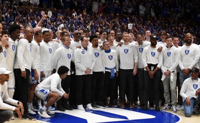 Duke Blue Devils head coach Mike Krzyzewski poses for a picture with his former and current players prior to his final home game at Cameron Indoor Stadium.