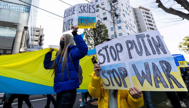 Protestors hold placards as they take part in a protest against Russia's actions in Ukraine during a rally in Tokyo.