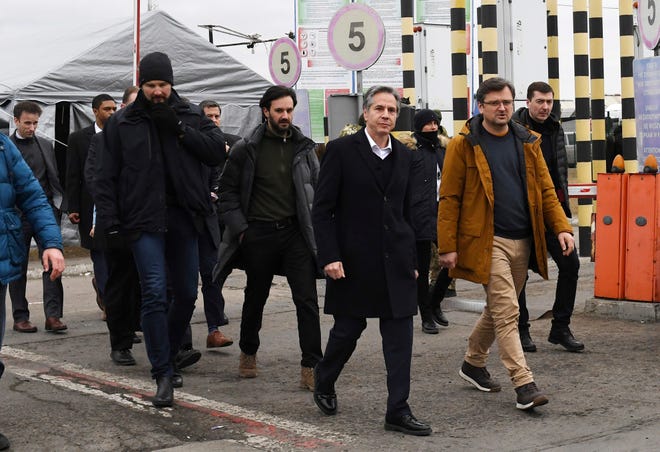 U.S. Secretary of State Antony Blinken, center, and Ukrainian Foreign Minister Dmytro Kuleba, second right, walk together after meeting at the Ukrainian-Polish border crossing in Korczowa, Poland, Saturday, March 5, 2022.