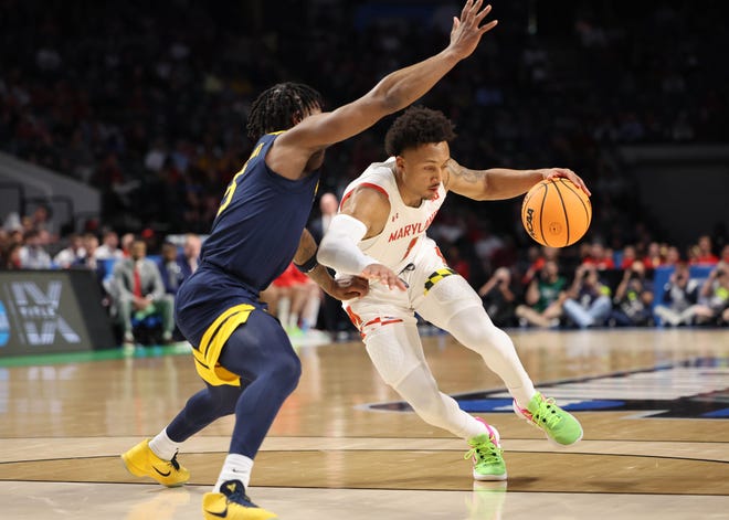 Maryland Terrapins guard Jahmir Young (1) dribbles against West Virginia Mountaineers guard Joe Toussaint (5) during the first half in the first round of the 2023 NCAA Tournament at Legacy Arena.