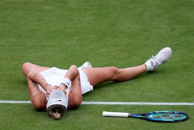 Czech&#x20;Republic&#x27;s&#x20;Marketa&#x20;Vondrousova&#x20;lays&#x20;on&#x20;the&#x20;court&#x20;as&#x20;she&#x20;reacts&#x20;after&#x20;beating&#x20;Tunisia&#x27;s&#x20;Ons&#x20;Jabeur&#x20;to&#x20;win&#x20;the&#x20;final&#x20;of&#x20;the&#x20;women&#x27;s&#x20;singles&#x20;on&#x20;day&#x20;thirteen&#x20;of&#x20;the&#x20;Wimbledon&#x20;tennis&#x20;championships&#x20;in&#x20;London,&#x20;Saturday,&#x20;July&#x20;15,&#x20;2023.&#x20;&#x28;AP&#x20;Photo&#x2F;Kirsty&#x20;Wigglesworth&#x29;